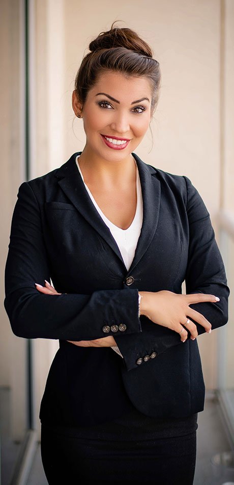 A female legal professional smiles at the camera